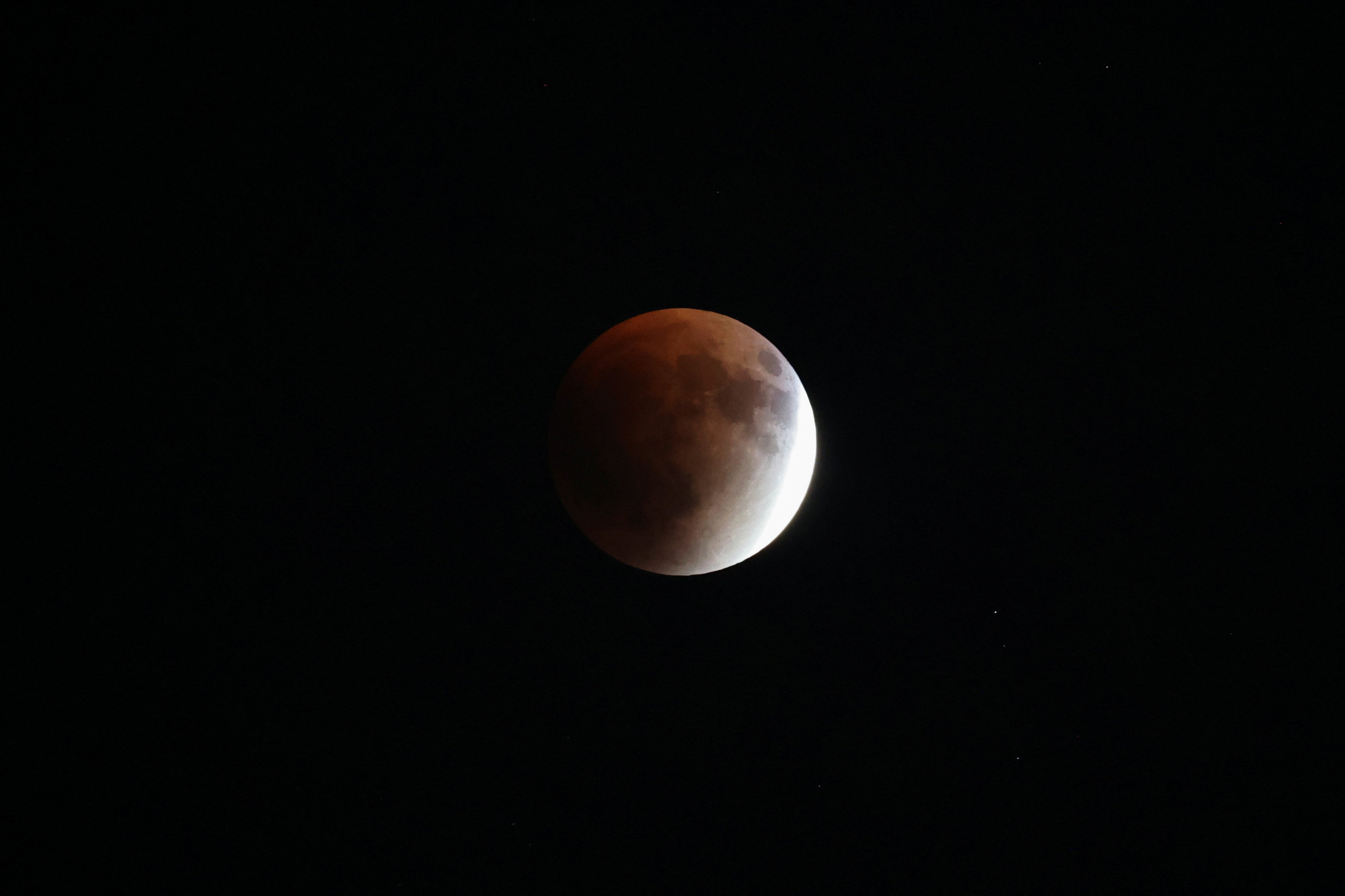 The "Blood Moon" rises in the sky during a total lunar eclips
